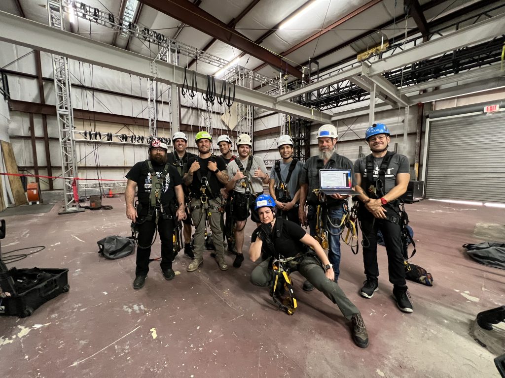Rhino Florida team members pose at the FL training center following SPRAT certification training there. In the photo are Rhino Director of Safety and Training Matt Hudson, second from right, and Assistant Director of Safety and Training Siobhan Colleen, in front.