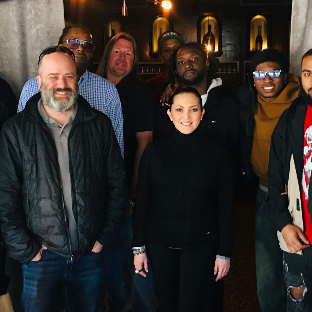 Rhino Northeast team members pose together at a restaurant in Boston. Rhino National Business Development Manager Tammy Dooley is front and center.